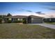 Charming single-story home with a well-maintained lawn and attached two-car garage at 26103 Salonika Ln, Punta Gorda, FL 33983