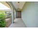 Inviting front porch featuring a tiled walkway and covered entrance with beautiful landscaping at 26103 Salonika Ln, Punta Gorda, FL 33983