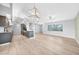 Spacious open-concept living room features modern flooring and a stylish kitchen with sleek appliances at 26103 Salonika Ln, Punta Gorda, FL 33983