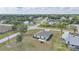 Aerial view of the property showing its placement in a serene neighborhood with lush landscaping at 27306 Deep Creek Blvd, Punta Gorda, FL 33983