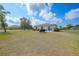 Expansive backyard with ample green space, patio, and grill, perfect for outdoor gatherings at 27306 Deep Creek Blvd, Punta Gorda, FL 33983