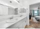Clean bathroom features double sinks with modern faucets and a large vanity mirror at 27306 Deep Creek Blvd, Punta Gorda, FL 33983