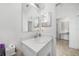 Bathroom featuring a vanity, a large mirror and modern fixtures at 27306 Deep Creek Blvd, Punta Gorda, FL 33983