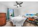 Well-lit bedroom featuring a work space, a comfortable bed, and neutral wall paint at 27306 Deep Creek Blvd, Punta Gorda, FL 33983