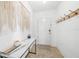 Inviting entryway featuring a marble console table, modern decor, coat hooks, and neutral tile flooring at 27306 Deep Creek Blvd, Punta Gorda, FL 33983