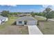 Charming single-story home featuring a well-manicured lawn and attached two-car garage in a quiet neighborhood at 27306 Deep Creek Blvd, Punta Gorda, FL 33983