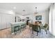 Bright kitchen and dining area featuring white cabinets, stainless steel appliances, and stylish decor at 27306 Deep Creek Blvd, Punta Gorda, FL 33983