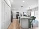Bright open kitchen featuring white cabinetry, modern appliances, a breakfast bar, and adjoining dining space at 27306 Deep Creek Blvd, Punta Gorda, FL 33983