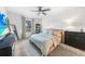 Cozy main bedroom features a ceiling fan, a large window and ample natural light at 27306 Deep Creek Blvd, Punta Gorda, FL 33983
