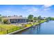 Back of house aerial view with pool, canal and private dock, ideal for boating at 2911 Riverside Dr, Punta Gorda, FL 33950