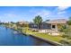 Aerial view of waterfront home with a screened pool, boat dock, and lush green lawn, a boater's paradise at 2911 Riverside Dr, Punta Gorda, FL 33950
