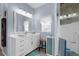 Bathroom featuring a vanity, a walk-in shower, and modern fixtures and a window at 2911 Riverside Dr, Punta Gorda, FL 33950