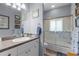 Well-lit bathroom featuring a tub shower with sliding glass doors and a neutral-toned countertop at 2911 Riverside Dr, Punta Gorda, FL 33950