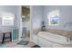 Bathroom showcases a garden tub with tile surround, a shower and a window at 2911 Riverside Dr, Punta Gorda, FL 33950