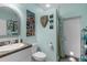 Unique bathroom design with artistic decor, a walk-in shower, and a convenient outdoor access door at 2911 Riverside Dr, Punta Gorda, FL 33950