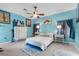 Charming bedroom with blue walls, ceiling fan, and a bright, airy atmosphere at 2911 Riverside Dr, Punta Gorda, FL 33950