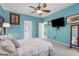 Inviting bedroom with calming blue walls, large TV, and easy access to bathroom at 2911 Riverside Dr, Punta Gorda, FL 33950
