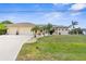 Charming single-story home featuring a spacious three-car garage, lush lawn, and inviting curb appeal at 2911 Riverside Dr, Punta Gorda, FL 33950