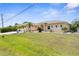 Charming single-story home featuring a spacious three-car garage, lush lawn, and manicured landscaping at 2911 Riverside Dr, Punta Gorda, FL 33950