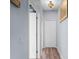 Hallway with two white doors and a decorative ceiling lamp, featuring a clean and simple design at 2911 Riverside Dr, Punta Gorda, FL 33950