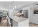 Bright, updated kitchen with a spacious island, white cabinetry, pendant lights, and stainless steel appliances at 2911 Riverside Dr, Punta Gorda, FL 33950