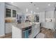 Modern kitchen with white cabinets, stainless steel appliances, an island with bar seating, and pendant lighting at 2911 Riverside Dr, Punta Gorda, FL 33950