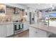 Updated kitchen with stainless steel appliances, custom backsplash, and a view of the backyard at 2911 Riverside Dr, Punta Gorda, FL 33950