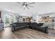 Spacious living room with a large sectional sofa, ceiling fan, and hardwood floors leading to the kitchen at 2911 Riverside Dr, Punta Gorda, FL 33950