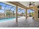 Screened patio with a pool and a spa, ceiling fan, and outdoor seating and grill at 2911 Riverside Dr, Punta Gorda, FL 33950