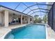 Spacious screened-in lanai with a pristine pool and views of the home's covered patio area at 2911 Riverside Dr, Punta Gorda, FL 33950