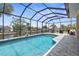 Beautiful screened pool with canal view and outdoor seating area, perfect for relaxation and entertaining at 2911 Riverside Dr, Punta Gorda, FL 33950