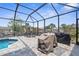 Inviting outdoor entertaining space featuring a screened pool and outdoor dining area overlooking the canal at 2911 Riverside Dr, Punta Gorda, FL 33950