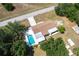 Aerial view of a home with a private pool, surrounded by mature trees and a long driveway at 30154 Beech Rd, Punta Gorda, FL 33982