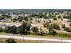 Residential neighborhood aerial view featuring a home with an in-ground pool and spacious yards at 30154 Beech Rd, Punta Gorda, FL 33982
