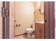 Cozy bathroom featuring a vanity with wood cabinetry, a toilet, and a framed mirror above the sink at 30154 Beech Rd, Punta Gorda, FL 33982
