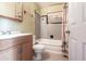 Well-lit bathroom featuring a vanity, toilet, and tub-shower combination, perfect for relaxation at 30154 Beech Rd, Punta Gorda, FL 33982