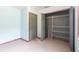 Bedroom closet with shelving, painted walls, and light-colored tile flooring at 30154 Beech Rd, Punta Gorda, FL 33982