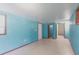 Bright bedroom featuring blue painted walls, tile flooring, and natural light, creating a serene atmosphere at 30154 Beech Rd, Punta Gorda, FL 33982