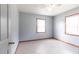 Bright bedroom featuring neutral walls, tile flooring, and windows offering natural light, creating a peaceful atmosphere at 30154 Beech Rd, Punta Gorda, FL 33982