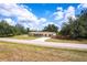 Charming single-story home featuring a well-maintained lawn and a cozy covered front porch at 30154 Beech Rd, Punta Gorda, FL 33982