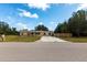 Quaint one-story home featuring a front porch and driveway, set amidst a lawn and mature trees at 30154 Beech Rd, Punta Gorda, FL 33982
