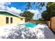 Backyard pool area with clear blue water, white patio, and partial fence enclosure at 30154 Beech Rd, Punta Gorda, FL 33982