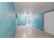 Bright room featuring blue painted walls, tile flooring, and multiple doorways, creating an open and inviting space at 30154 Beech Rd, Punta Gorda, FL 33982