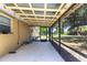 View of covered screened porch with concrete floors and view of backyard at 30154 Beech Rd, Punta Gorda, FL 33982