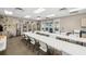 Spacious activity room with large folding tables, display shelving, and sink area for arts and crafts at 3050 Rivershore Ln, Port Charlotte, FL 33953