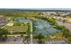 Aerial view of community tennis and pickleball courts, meticulously maintained and surrounded by lush landscaping at 3050 Rivershore Ln, Port Charlotte, FL 33953