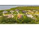 Aerial view of a home with a screened-in pool in a scenic waterside community at 3050 Rivershore Ln, Port Charlotte, FL 33953