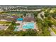 Aerial view showcasing community amenities, including a pool, tennis courts, and a well-maintained clubhouse at 3050 Rivershore Ln, Port Charlotte, FL 33953