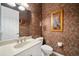 Stylish bathroom featuring a modern vanity, decorative lighting, and unique wall accents at 3050 Rivershore Ln, Port Charlotte, FL 33953