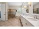 Bright bathroom with double sinks, a glass shower, and separate tub at 3050 Rivershore Ln, Port Charlotte, FL 33953